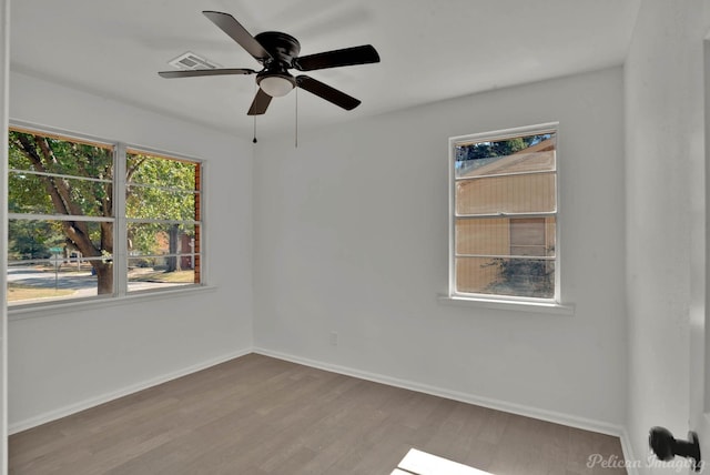 spare room with light hardwood / wood-style floors and ceiling fan