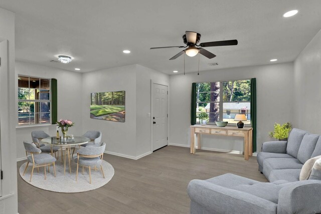 living room with ceiling fan, plenty of natural light, and hardwood / wood-style flooring