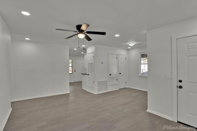 unfurnished living room with ceiling fan and light wood-type flooring