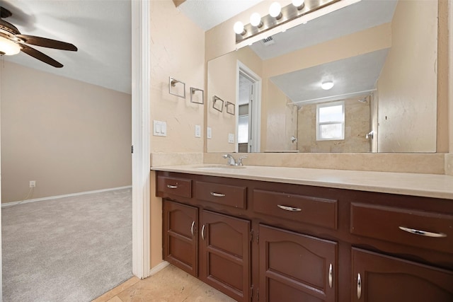 bathroom with a shower, ceiling fan, and vanity