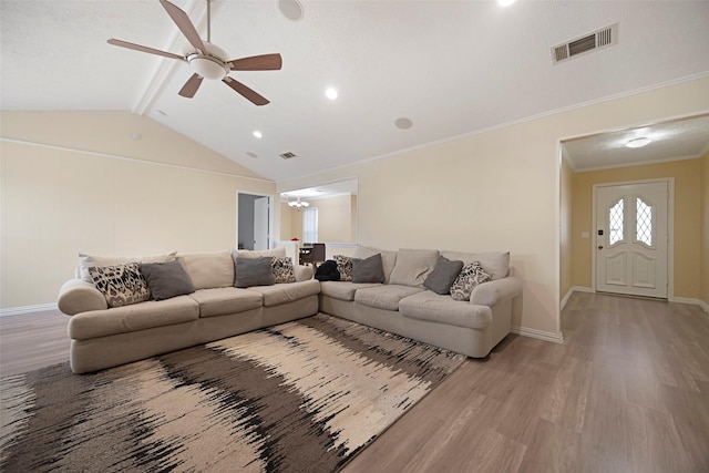 living room featuring vaulted ceiling with beams, crown molding, light hardwood / wood-style floors, and ceiling fan with notable chandelier