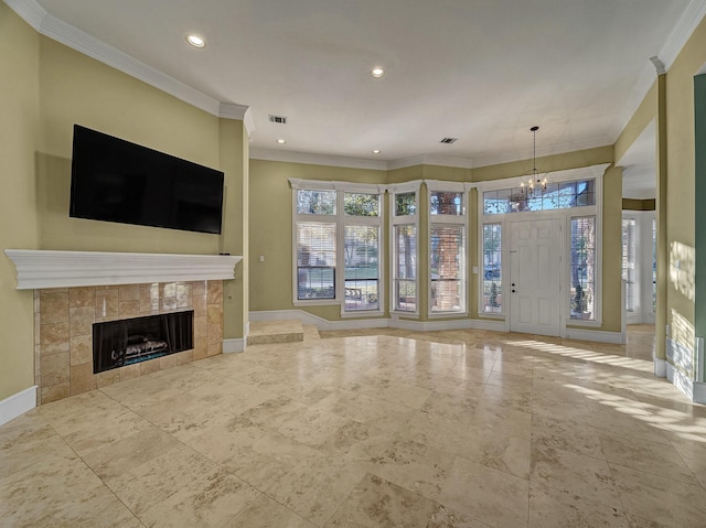 unfurnished living room featuring a notable chandelier, ornamental molding, and a tiled fireplace