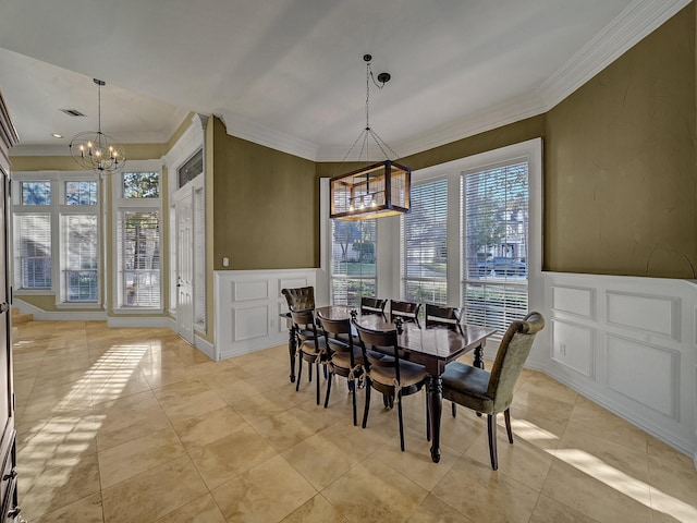 dining room with crown molding and an inviting chandelier