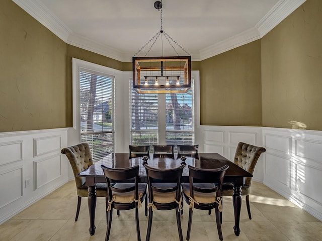 dining area featuring a notable chandelier, ornamental molding, and light tile patterned floors