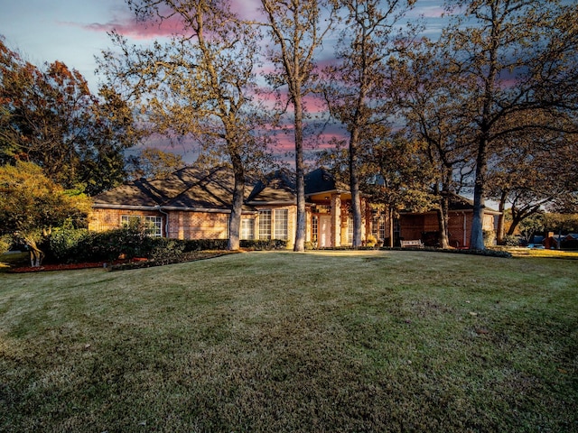 view of front of house with a yard and a garage