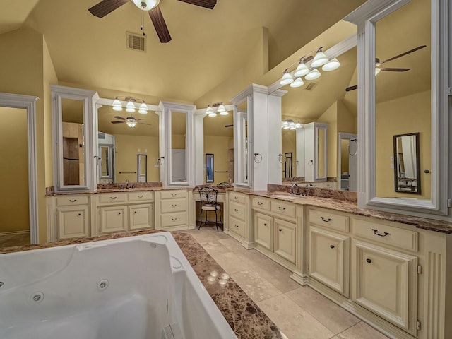 bathroom with lofted ceiling, vanity, ceiling fan, and a tub to relax in