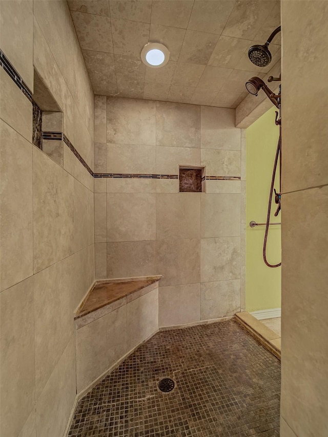 bathroom with tiled shower