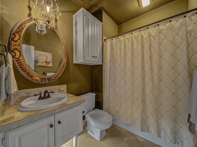 bathroom with tile patterned floors, walk in shower, vanity, and toilet