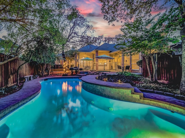 view of pool at dusk