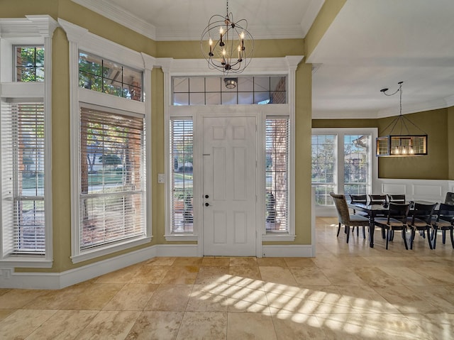 entryway featuring a notable chandelier, plenty of natural light, and ornamental molding