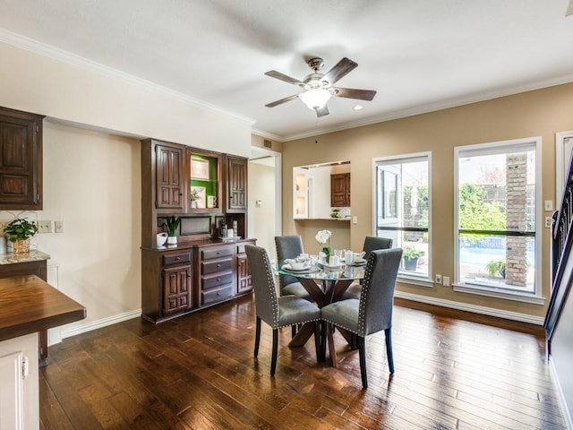 dining space featuring ceiling fan, dark hardwood / wood-style flooring, and crown molding