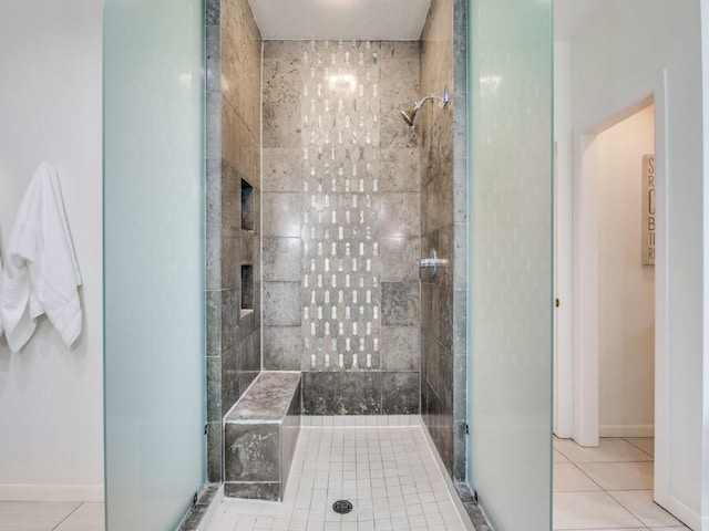 bathroom featuring tile patterned floors and tiled shower