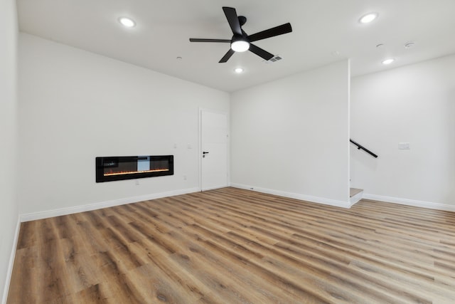 empty room featuring ceiling fan and light hardwood / wood-style flooring