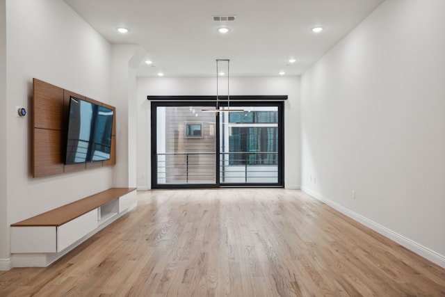 unfurnished living room with light hardwood / wood-style flooring