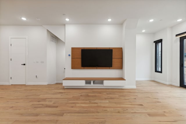 unfurnished living room featuring light hardwood / wood-style floors