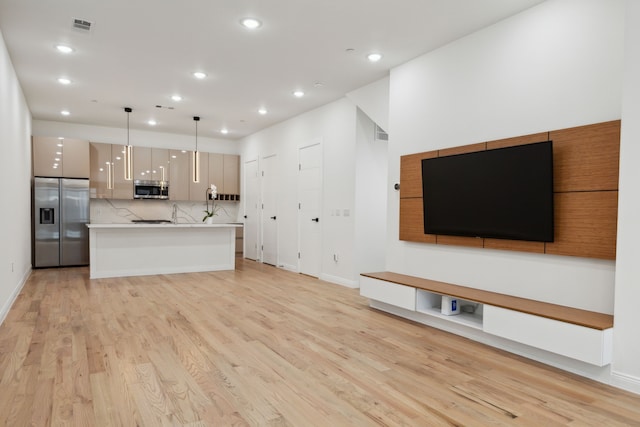 unfurnished living room featuring light wood-type flooring