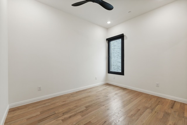 spare room with light hardwood / wood-style floors and ceiling fan