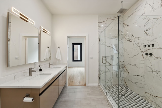 bathroom with a shower with door and vanity