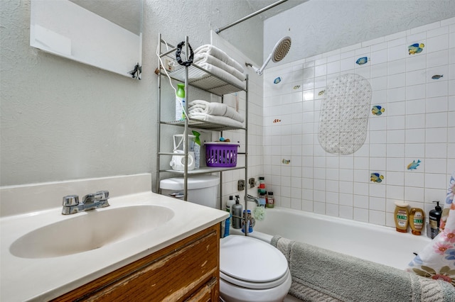 full bathroom with vanity, shower / tub combo with curtain, and toilet