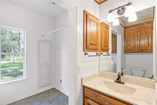 bathroom with tile patterned flooring, vanity, and ornamental molding