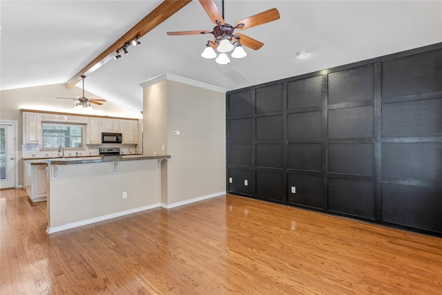 kitchen featuring light stone counters, lofted ceiling with beams, kitchen peninsula, light hardwood / wood-style floors, and a breakfast bar area