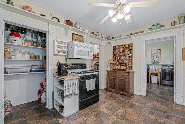 kitchen featuring washer / clothes dryer, ceiling fan, and black range