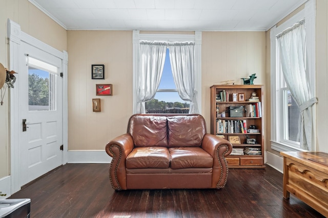 sitting room with ornamental molding, dark hardwood / wood-style floors, and a healthy amount of sunlight