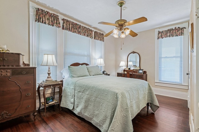 bedroom with ceiling fan and dark hardwood / wood-style flooring