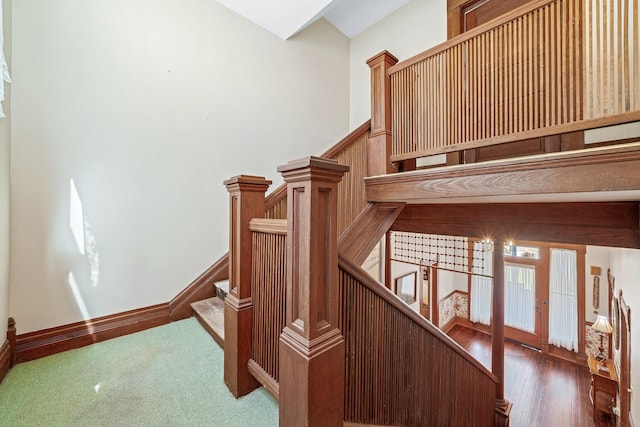 stairway with hardwood / wood-style floors and french doors