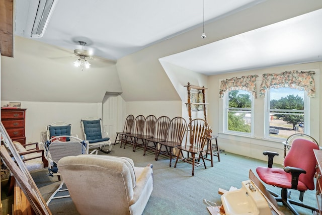 living area with light carpet, ceiling fan, and lofted ceiling