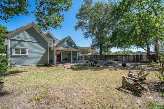 back of property featuring a patio area and a yard