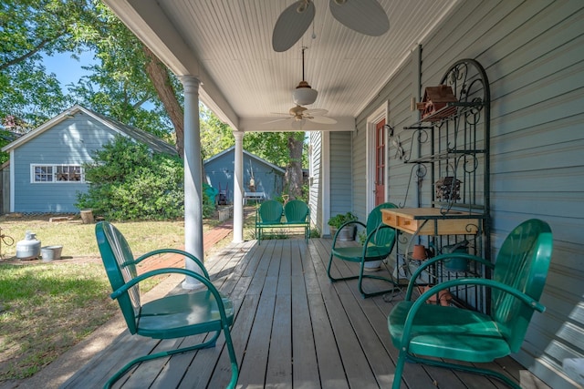 wooden terrace with a porch and ceiling fan