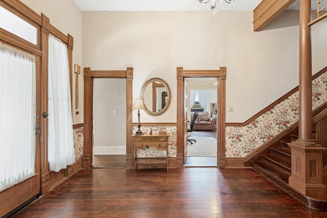 foyer with a notable chandelier, dark hardwood / wood-style floors, and a healthy amount of sunlight