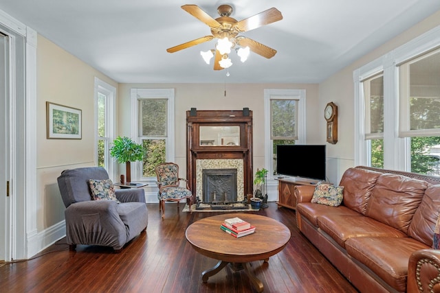 living room featuring ceiling fan, a healthy amount of sunlight, and dark hardwood / wood-style flooring