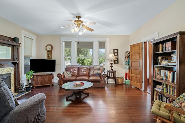 living room with ceiling fan and dark hardwood / wood-style flooring