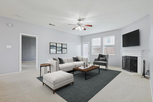 living room featuring ceiling fan and light colored carpet