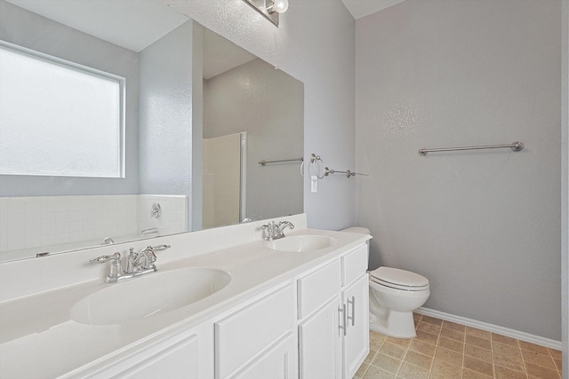 bathroom featuring a washtub, toilet, and vanity