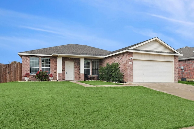 view of front of home with a garage and a front lawn