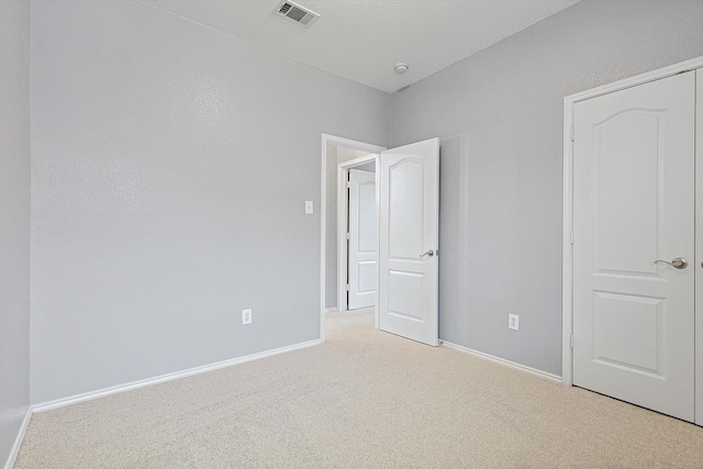 unfurnished bedroom with light carpet