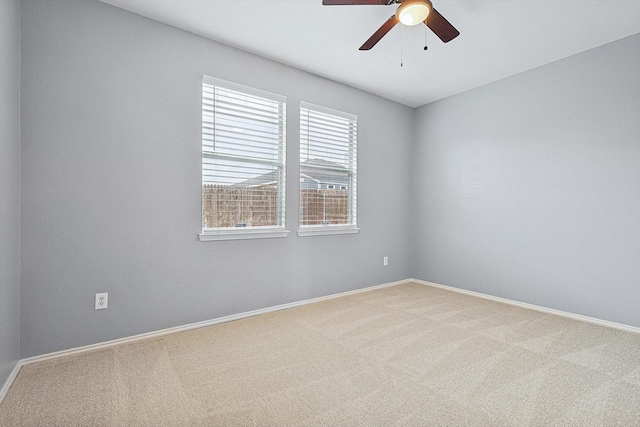 spare room featuring carpet flooring and ceiling fan