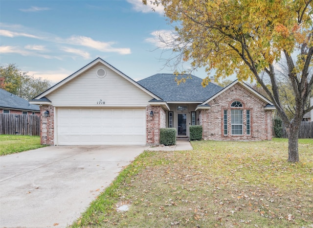 ranch-style home with a front yard and a garage