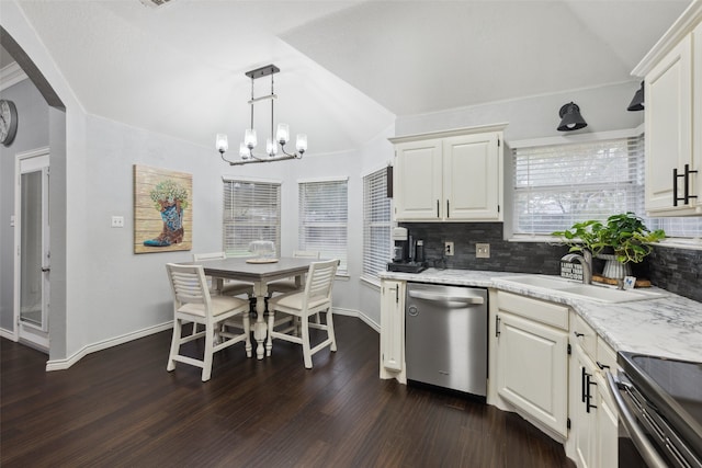 kitchen with decorative backsplash, appliances with stainless steel finishes, dark wood-type flooring, sink, and decorative light fixtures