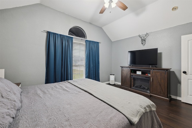 bedroom with ceiling fan, dark hardwood / wood-style floors, and vaulted ceiling