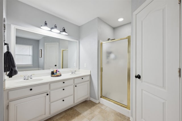 bathroom with tile patterned flooring, vanity, and walk in shower