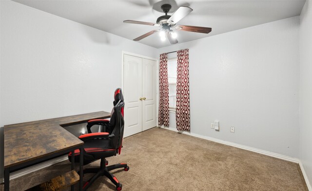 carpeted office space with ceiling fan