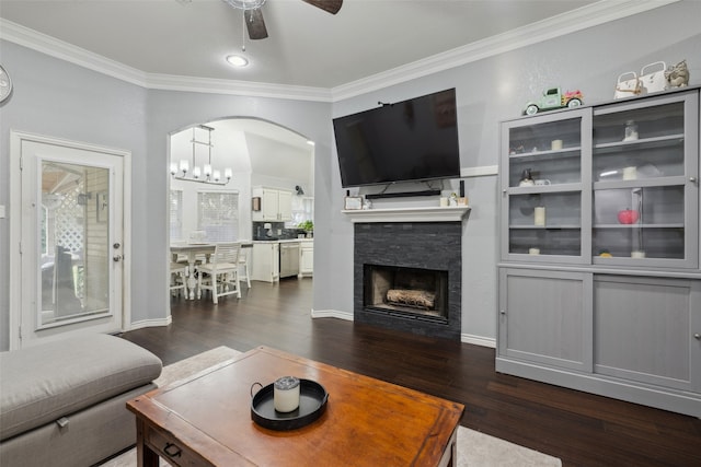 living room with crown molding, a fireplace, and dark wood-type flooring