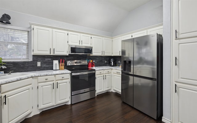 kitchen with sink, white cabinetry, stainless steel appliances, and dark wood-type flooring