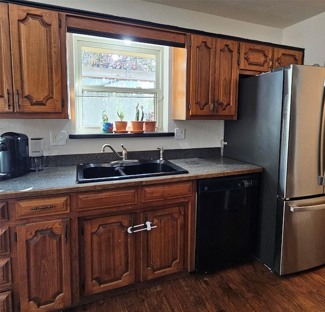 kitchen featuring stainless steel fridge, sink, dark wood-type flooring, and black dishwasher