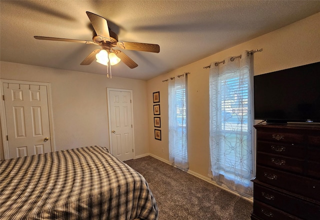 bedroom with carpet flooring, ceiling fan, and a textured ceiling