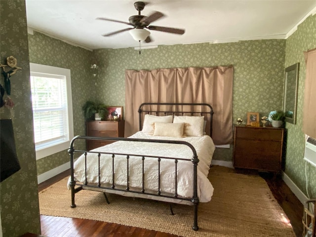 bedroom with hardwood / wood-style floors, ceiling fan, and crown molding